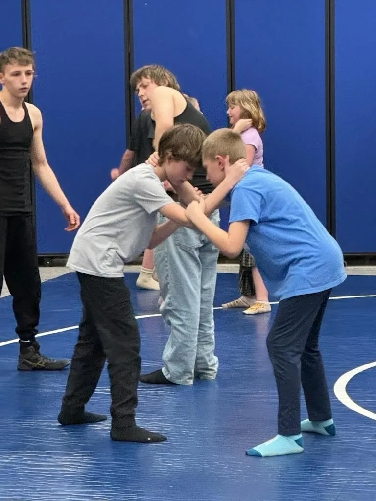 Students of all ages practicing together in the gym